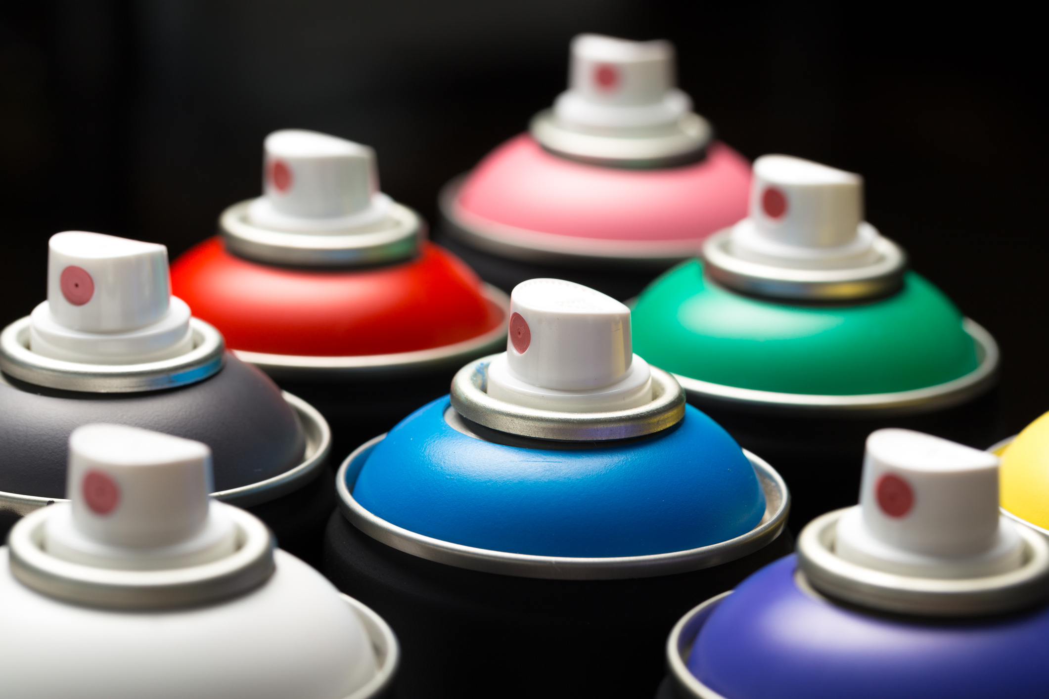 multi colored cans of spray paint