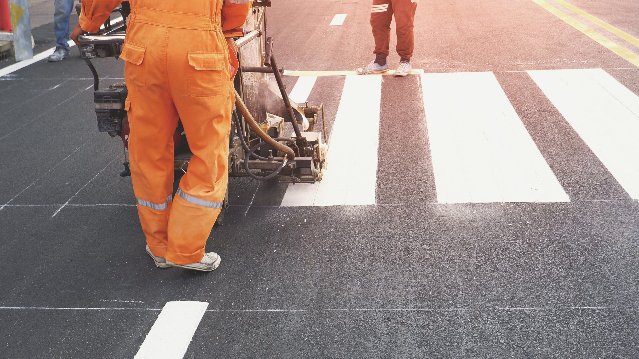 Road crew with crosswalk painting